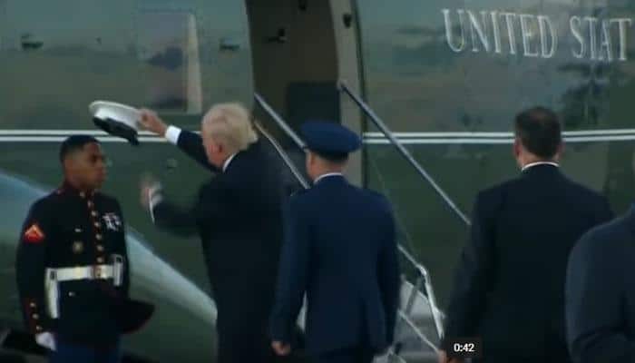 WATCH: Donald Trump stops to pick up hat that flew off Marine&#039;s head, pats on his arm
