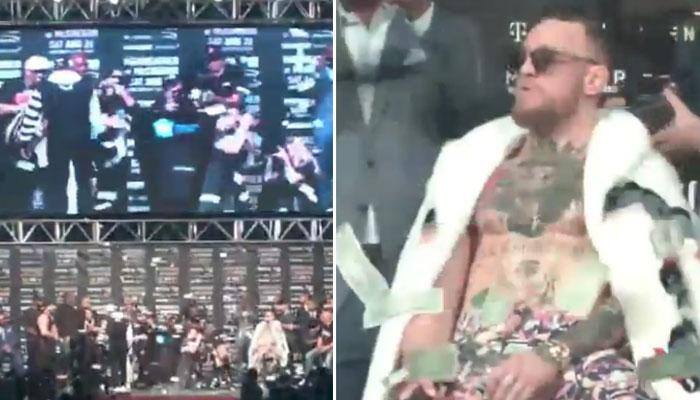 WATCH: Floyd Mayweather Jr showers dollar bills on Conor McGregor ahead of their much-anticipated fight