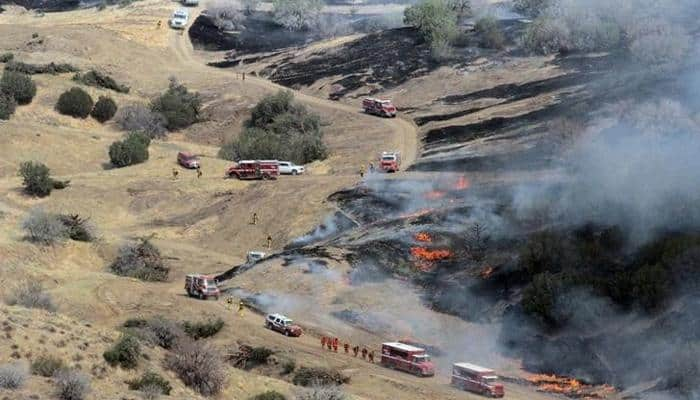 Huge California wildfire spreads overnight as crews dig in