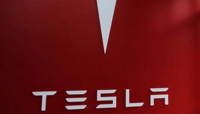 Tesla's Elon Musk hands over first Model 3 electric cars to early buyers