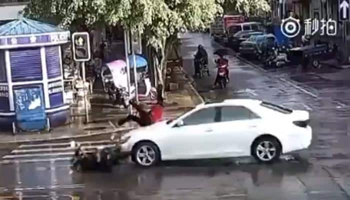 Biker in China escapes death by whisker - WATCH