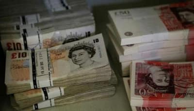 British inflation jumps, pushing pound to one-year dollar high