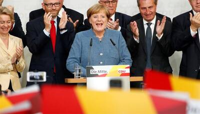 Angela Merkel wins fourth term as far-right enters German Parliament