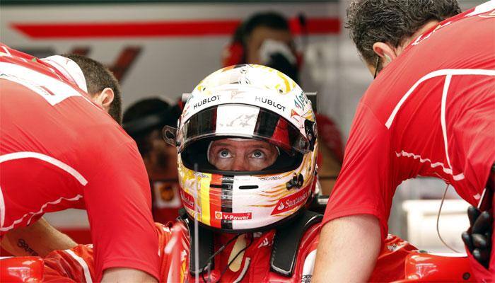 Sebastian Vettel smiling through the pain of qualifying last