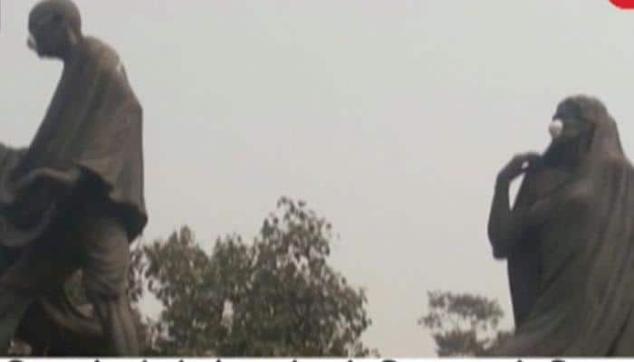 Delhi MLAs Kapil Mishra and Manjinder Singh Sirsa tie protective mask on Mahatma Gandhi's statue