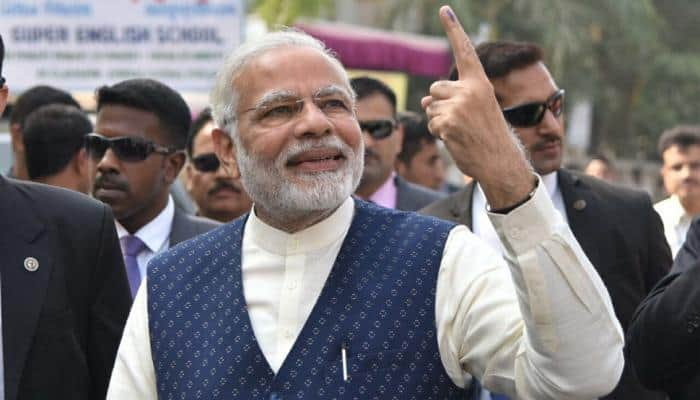 A mini roadshow in Ranip as PM Narendra Modi stands in queue, casts his vote