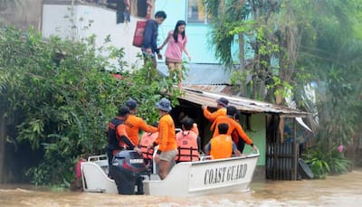 Two dead, thousands flee in storm-weary Philippines