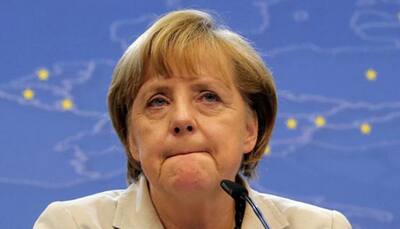 Merkel under fire from own ranks over German coalition deal
