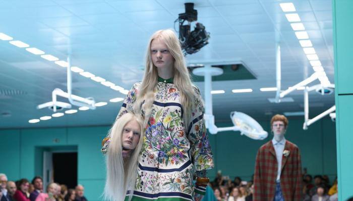 Gucci models walk runway — holding replica of severed heads, dragons and snakes