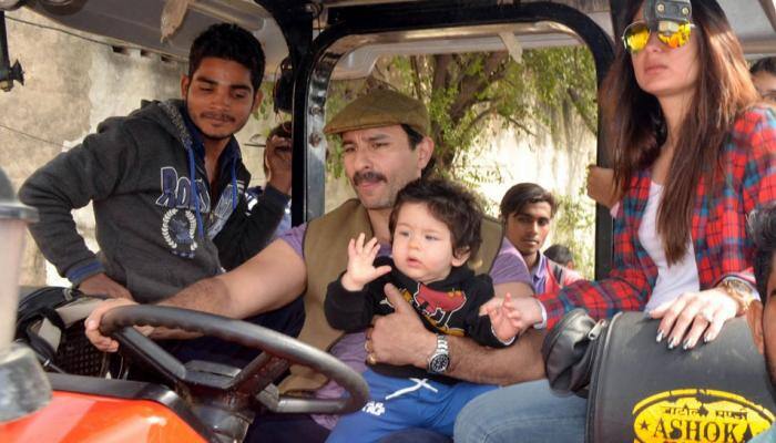 Taimur Ali Khan chilling like a boss on daddy Saif Ali Khan&#039;s lap while mommy Kareena looks at him—Pics