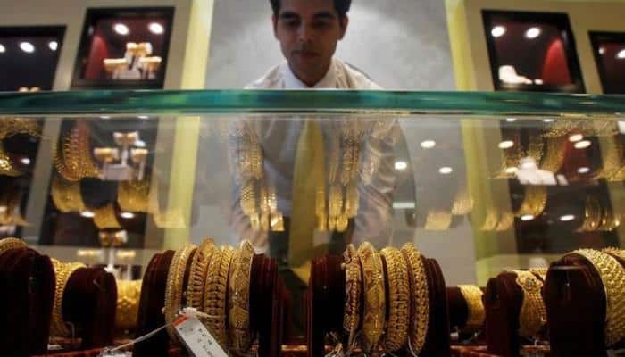 Silver falls on muted demand, gold ends steady