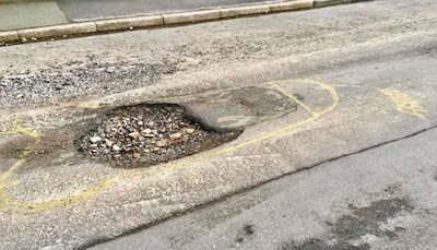 Man draws human organs around potholes to 'wake up authorities'