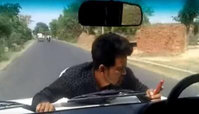 Watch: Shocking video shows government official driving with protesting man on bonnet