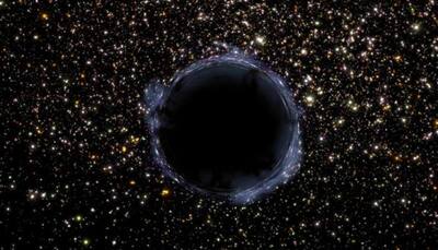 Space hum may reveal hidden black holes