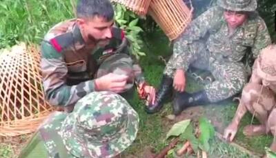 Indian soldiers learn techniques to light fire in jungle from Malaysian troopers