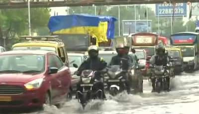 Heavy showers in Mumbai: Commuters struggle on water-logged roads, train services hit