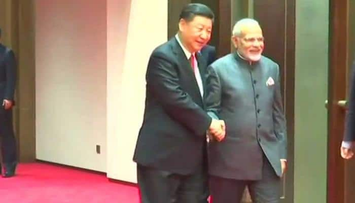 In Qingdao, China&#039;s Xi Jinping greets PM Narendra Modi with a handshake and smile ahead of SCO Summit