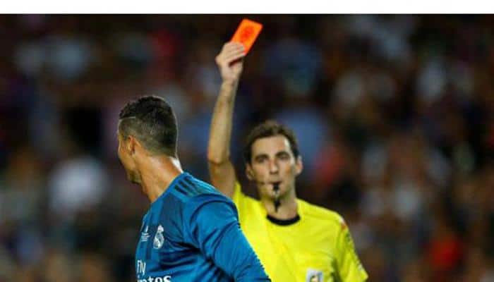 Football referees watching slow motion videos flash more red cards