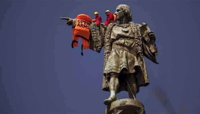 Woman climbs base of Statue of Liberty to protest Donald Trump&#039;s immigration policy