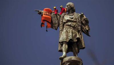 Woman climbs base of Statue of Liberty to protest Donald Trump's immigration policy