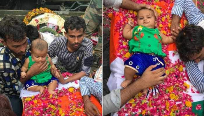 Martyr&#039;s five-month-old daughter sits on his coffin, moves everyone to tears