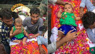 Martyr's five-month-old daughter sits on his coffin, moves everyone to tears