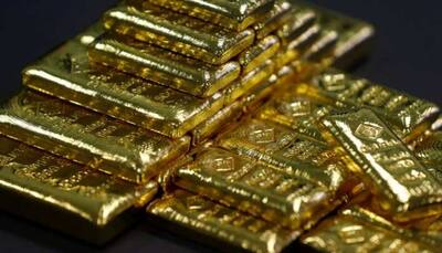 Gold slips to 1-year low as US dollar firms