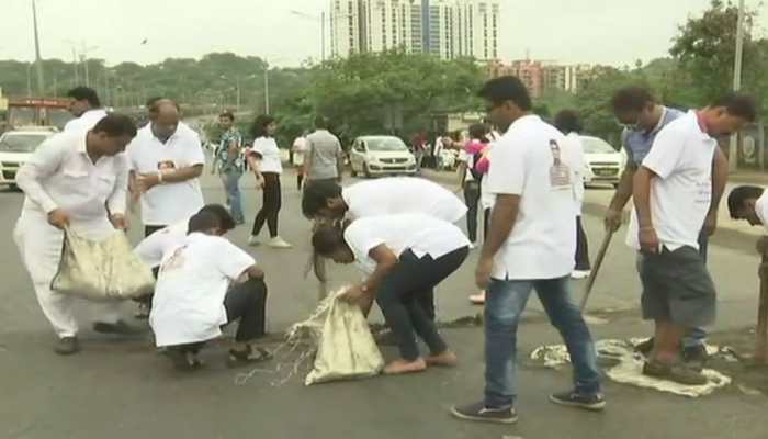 Mumbai man fills potholes for three years after losing son to road accident Mumbai man fills potholes for three years after losing son to road accident