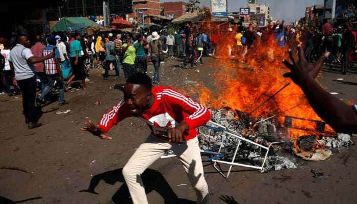 Opposition protesters clash with police as ruling party wins majority in Zimbabwe, one dead