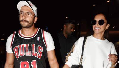 Deepika Padukone is all smiles as she walks hand-in-hand with Ranveer Singh at the airport - See pics