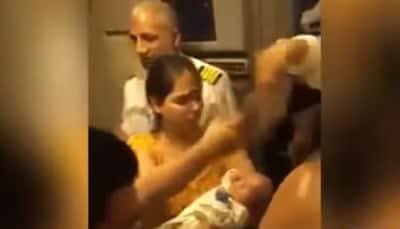 Woman pleads to PIA crew to open flight doors as baby falls unconscious, video emerges