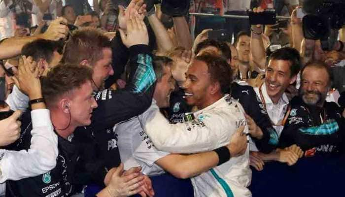 Motor racing: &#039;Spent&#039; Hamilton soaks up special victory in Singapore