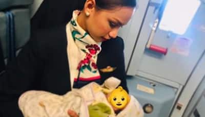 Air hostess breastfeeds hungry baby onboard flight as mother runs out of formula milk, wins accolades