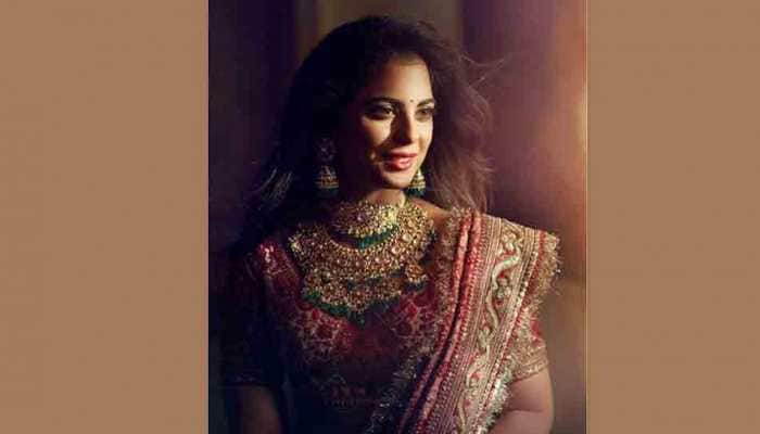 Isha Ambani looks regal in red Sabyasachi lehenga for pre-wedding puja — See photos