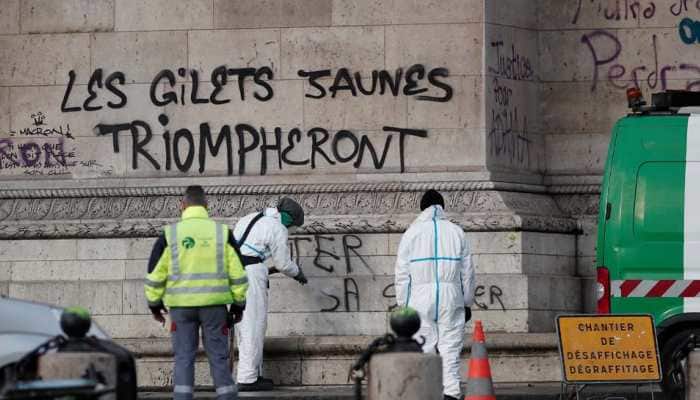 French President Emmanuel Macron visits riot-damaged Arc de Triomphe, state of emergency mulled