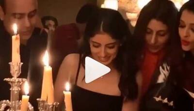 Aaradhya Bachchan looks on while sister Navya Naveli Nanda cuts her birthday cake-Watch