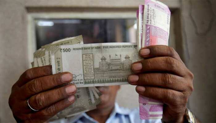 Rupee breaches 71 per dollar on ''chunky outflows''