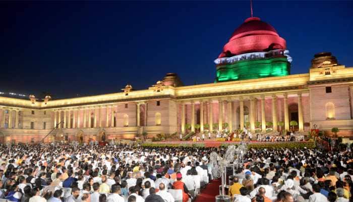 White kurta-pyjama with hues of saffron and Hindi language dominating themes at swearing-in ceremony