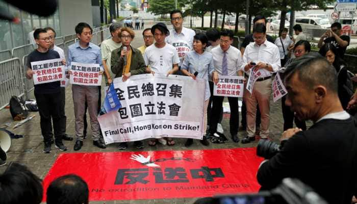 Protesters scuffle with Hong Kong police, government offices shut