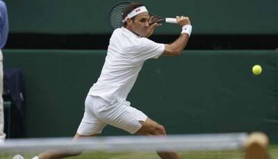Federer bags more records as he downs Pouille to reach Wimbledon last 16