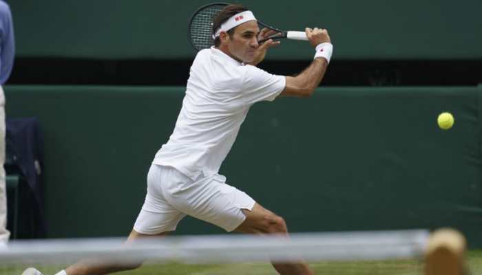 Federer bags more records as he downs Pouille to reach Wimbledon last 16