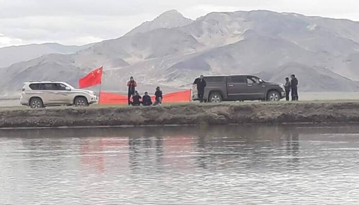 Chinese Army men in 'civilian clothes' show banner supporting Tibet to villagers in Ladakh