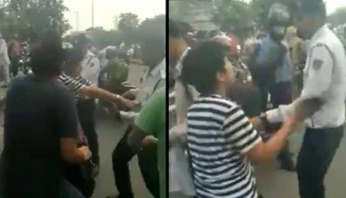 Watch: Stopped for not wearing helmet in Delhi, woman abuses, clashes with traffic cop