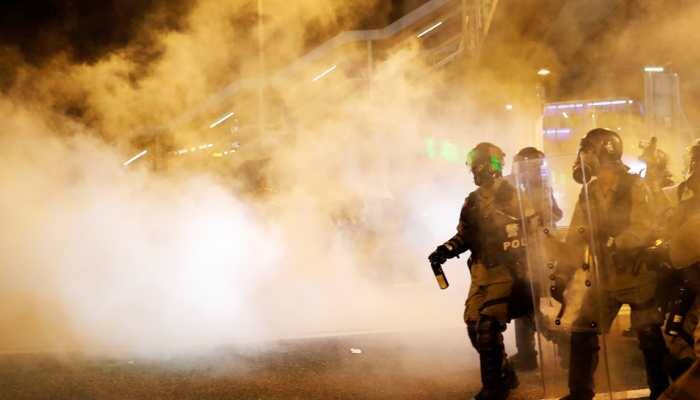Hong Kong police fire tear gas at protestors as strikes paralyse city 