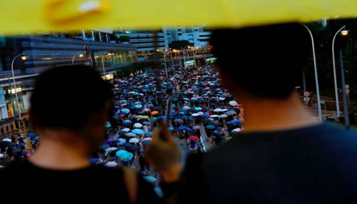 Hong Kong protesters throng streets peacefully in pouring rain