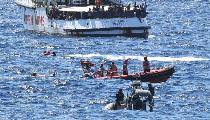 Tensions rise after 10 jump from migrant ship stranded off Italy 