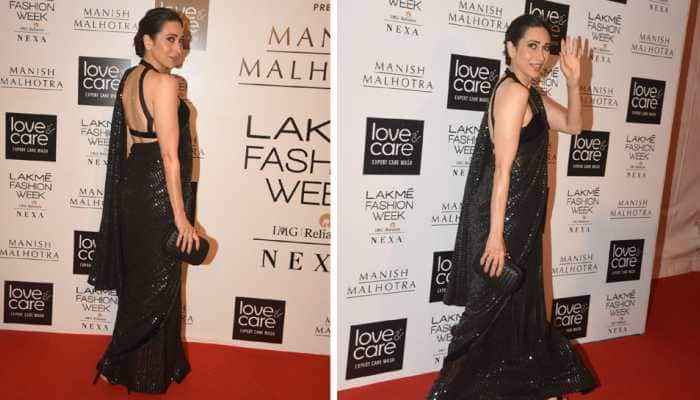 Karisma Kapoor looks alluring in a backless blouse and shimmering black saree—Photos