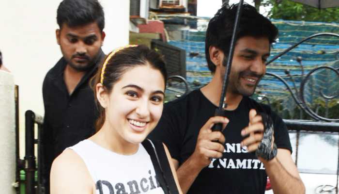 Kartik Aaryan holds an umbrella for Sara Ali Khan amid smiles, laughter and rain! See pics