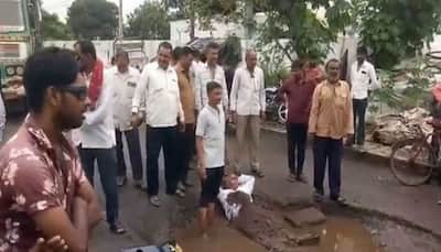 Potholes as bed: Rajkot man lies on broken roads to protest civic apathy