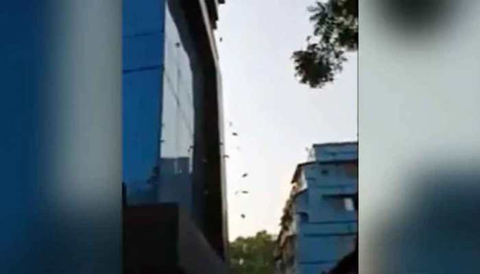 Bundles of currency notes thrown from Kolkata building during DRI raid - WATCH